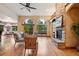 Spacious living room featuring hardwood floors, a stone fireplace, and natural light at 20401 High Pines Dr, Monument, CO 80132
