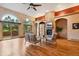 Comfortable living room showcasing a stone fireplace, wooden floors, and arched doorways at 20401 High Pines Dr, Monument, CO 80132