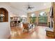 Open-concept living room with hardwood floors, arched windows, and easy access to the kitchen at 20401 High Pines Dr, Monument, CO 80132