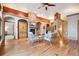 Bright living room featuring hardwood floors, a stone fireplace, and comfortable seating at 20401 High Pines Dr, Monument, CO 80132