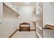 Walk-in closet includes built-in shelving, rods, and a decorative wooden bench at 20401 High Pines Dr, Monument, CO 80132