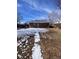 View of the brick home's backyard showcasing the partially snow-covered yard at 10866 Pearl St, Northglenn, CO 80233