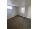 Unfinished basement with two egress windows and carpeted floor at 10866 Pearl St, Northglenn, CO 80233