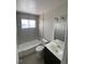 Clean bathroom with subway tile, white fixtures, vanity, and modern lighting at 10866 Pearl St, Northglenn, CO 80233