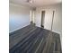 Inviting bedroom featuring dark laminate flooring, neutral walls, and a closet at 10866 Pearl St, Northglenn, CO 80233