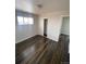 Bright bedroom features hardwood floors, neutral paint and a closet for ample storage at 10866 Pearl St, Northglenn, CO 80233