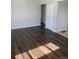 Light-filled living room features beautiful hardwood floors, neutral wall colors, and bright windows at 10866 Pearl St, Northglenn, CO 80233