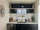 Bright kitchen featuring a stainless steel sink, white countertops, and subway tile backsplash at 1521 Yosemite St, Denver, CO 80220