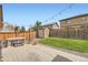 Private backyard featuring a stone patio, storage shed, string lights and a well-maintained lawn at 25128 E Maple Ave, Aurora, CO 80018