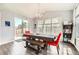 Bright dining area with large windows, sliding glass doors, and contemporary decor at 25128 E Maple Ave, Aurora, CO 80018