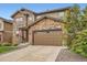 Beautiful two-story home with stone and siding, well-kept lawn, and a spacious two-car garage at 25128 E Maple Ave, Aurora, CO 80018