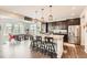 Modern kitchen connected to the dining area, featuring stainless steel appliances and a center island at 25128 E Maple Ave, Aurora, CO 80018