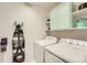 Bright laundry room with a washer, dryer, storage cabinets, and ironing board with Eiffel Tower design at 25128 E Maple Ave, Aurora, CO 80018