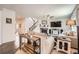 Spacious living room with a fireplace, staircase, modern decor, and hardwood floors at 25128 E Maple Ave, Aurora, CO 80018