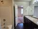 View from the bathroom to a bedroom with tiled shower over tub at 1211 Bistre St, Longmont, CO 80501