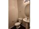 Neat half bathroom with a pedestal sink and a round mirror, offering a simple yet functional design at 1211 Bistre St, Longmont, CO 80501