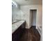 Bathroom featuring a double sink vanity with dark wood cabinets and tiled tub at 1211 Bistre St, Longmont, CO 80501
