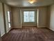 Comfortable bedroom with a large window, plush carpet, and ample space for relaxation and rest at 1211 Bistre St, Longmont, CO 80501