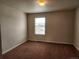 Cozy bedroom with neutral walls and large window providing natural light at 1211 Bistre St, Longmont, CO 80501