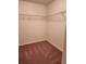 A compact, carpeted walk-in closet with wire shelving is ready for storage at 1211 Bistre St, Longmont, CO 80501
