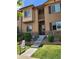 Close-up of a cozy townhome entrance with manicured landscaping and a welcoming staircase at 1211 Bistre St, Longmont, CO 80501