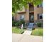 Inviting two-story townhome with a private balcony, stone accents, and manicured lawn at 1211 Bistre St, Longmont, CO 80501