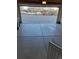 View of the concrete floored garage with open door leading to the driveway at 1211 Bistre St, Longmont, CO 80501