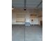 Clean garage featuring a service door, steps and plywood on the walls at 1211 Bistre St, Longmont, CO 80501