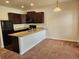 Well-lit kitchen featuring dark cabinets, updated appliances, and a breakfast bar at 1211 Bistre St, Longmont, CO 80501