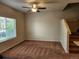 Inviting living room with neutral walls, plush carpet, and a ceiling fan for comfort at 1211 Bistre St, Longmont, CO 80501