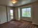 Bright living room featuring plush carpeting, and natural light from a large window at 1211 Bistre St, Longmont, CO 80501
