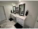 Modern bathroom with dual vanities, sleek mirrors, and stylish gray flooring at 2089 S Fultondale Way, Aurora, CO 80018