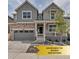 Charming two-story home featuring a welcoming front porch, stone accents, and a well-manicured front yard at 2089 S Fultondale Way, Aurora, CO 80018