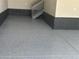 View of the epoxy floor of the garage, enhanced with a sleek gray and black trim at 2089 S Fultondale Way, Aurora, CO 80018