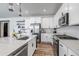 Modern kitchen featuring white cabinets, stainless steel appliances, and hardwood floors at 2089 S Fultondale Way, Aurora, CO 80018