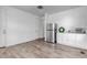 Bright kitchenette featuring stainless steel refrigerator, modern cabinets and flooring, and an undermount sink at 2089 S Fultondale Way, Aurora, CO 80018
