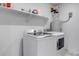 Bright laundry room with shelving and modern, front-loading appliances at 2089 S Fultondale Way, Aurora, CO 80018