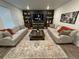 Inviting living room featuring stylish decor, a plush rug, and a dark accent wall at 2089 S Fultondale Way, Aurora, CO 80018