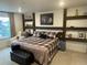 Cozy bedroom with built-in shelving, a plaid comforter, and natural light at 2089 S Fultondale Way, Aurora, CO 80018