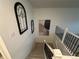 Carpeted staircase featuring black iron railings and natural light at 2089 S Fultondale Way, Aurora, CO 80018