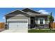 Charming single-Gathering home featuring a two-car garage, stone accents, and manicured lawn at 2225 Alyssa St, Fort Lupton, CO 80621