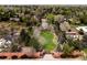 Aerial view of large lot with a circular driveway, brick fence and mature trees at 5425 S University Blvd, Greenwood Village, CO 80121