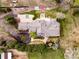 Aerial of luxury house boasting landscaping, circle driveway, sports court, fire pit and horse area at 5425 S University Blvd, Greenwood Village, CO 80121