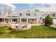Beautiful backyard featuring a fire pit with Adirondack chairs and landscaped lawn at 5425 S University Blvd, Greenwood Village, CO 80121