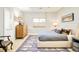 Cozy bedroom showcasing stylish furnishings, a patterned rug, and a large window for natural light at 5425 S University Blvd, Greenwood Village, CO 80121