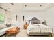 Serene bedroom with tray ceiling, textured wall hangings, and cozy seating area with contemporary wooden coffee table at 5425 S University Blvd, Greenwood Village, CO 80121
