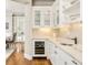Convenient butler's pantry with a wine fridge, custom cabinetry, and elegant marble countertops, ideal for entertaining at 5425 S University Blvd, Greenwood Village, CO 80121