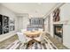 Inviting dining area with tiled floor, fireplace and a stylish accent wall with unique artwork at 5425 S University Blvd, Greenwood Village, CO 80121