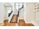 Grand entryway boasting hardwood floors, a staircase with dark railings, and abundant natural light at 5425 S University Blvd, Greenwood Village, CO 80121