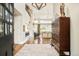 Stunning foyer with soaring ceilings, elegant light fixtures, hardwood floors, and a view of the inviting living space beyond at 5425 S University Blvd, Greenwood Village, CO 80121